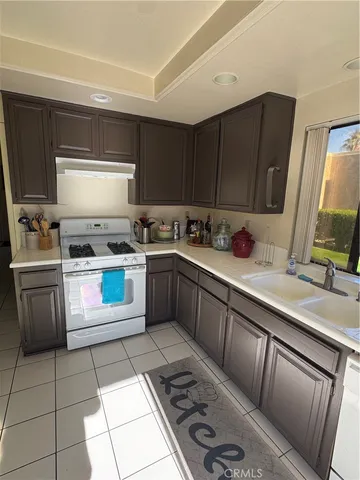 a kitchen with a stove sink and cabinets