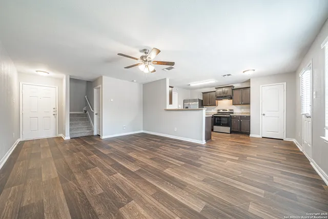 a view of a kitchen with a sink and a stove top oven
