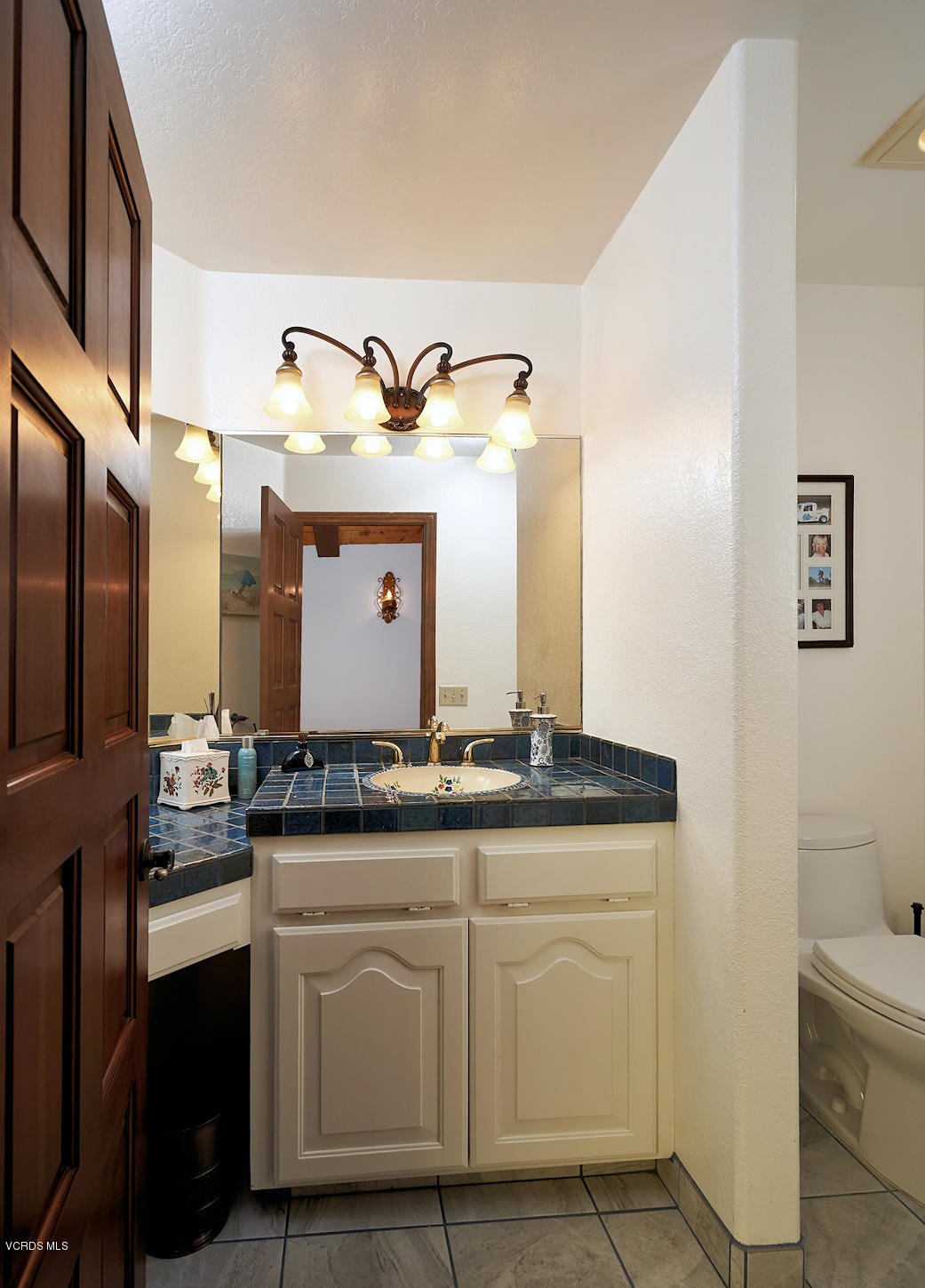 660 Via Con Dios Camarillo, CA 93010 - Photo 17 of 33 a bathroom with a granite countertop sink and a mirror