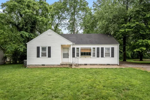 a house that has sitting area in the grass