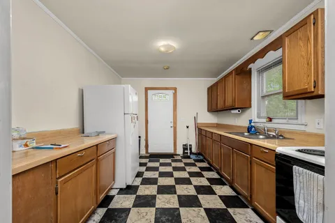 a kitchen with a sink a stove and cabinets