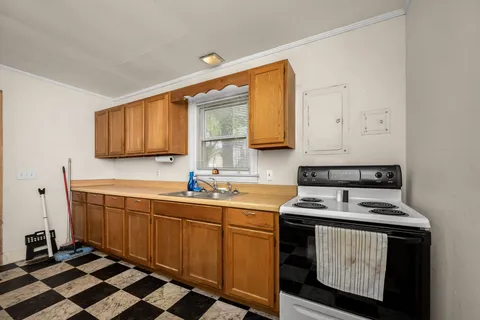 a kitchen with stainless steel appliances a stove a sink and a microwave
