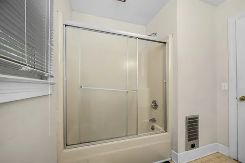 a bathroom with a shower and a tub