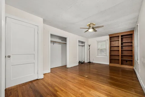 wooden floor in an empty room with a ceiling fan