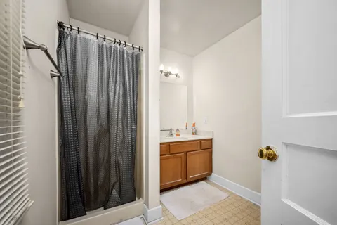 a bathroom with a sink a mirror and shower