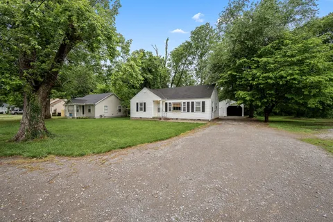 a view of house with garden and deck