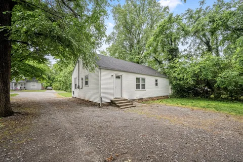 a view of a house with a yard and garage