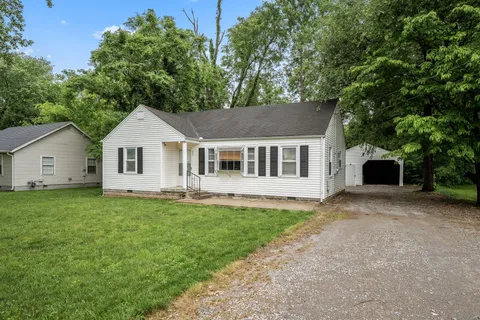 a house that has a tree in front of it