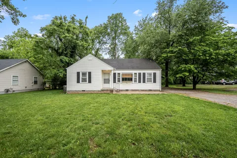 a front of a house with a garden
