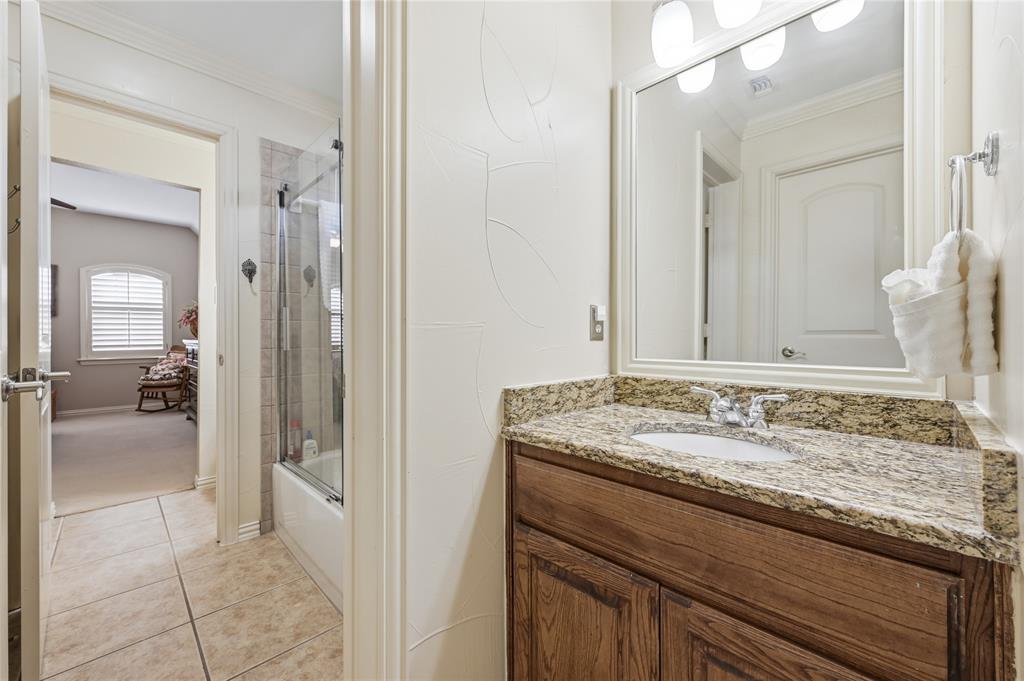 1316 Rio Grande Drive Allen, TX 75013 - Photo 28 of 40 a en suite bathroom with a granite countertop sink and a mirror