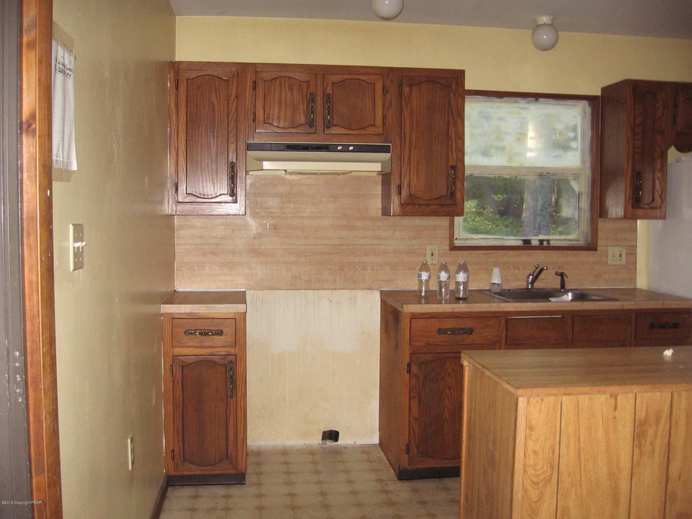 142 Doe Loop Bushkill, PA 18324 - Photo 6 of 10 a kitchen with stainless steel appliances granite countertop a sink stove and refrigerator