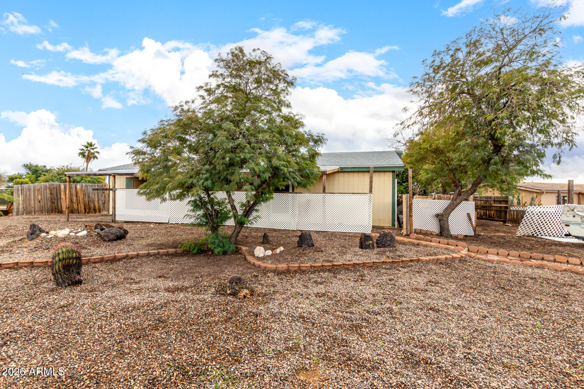 a backyard of a house with barbeque oven table and chairs