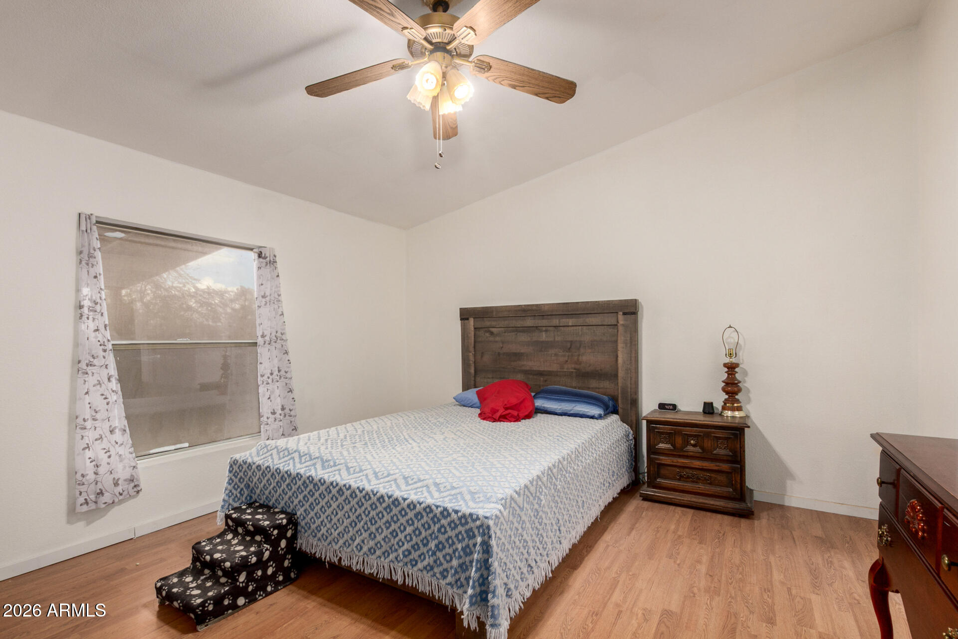 6751 West Nancy Road Peoria, AZ 85382 - Photo 14 of 29 a bedroom with a bed and a chandelier