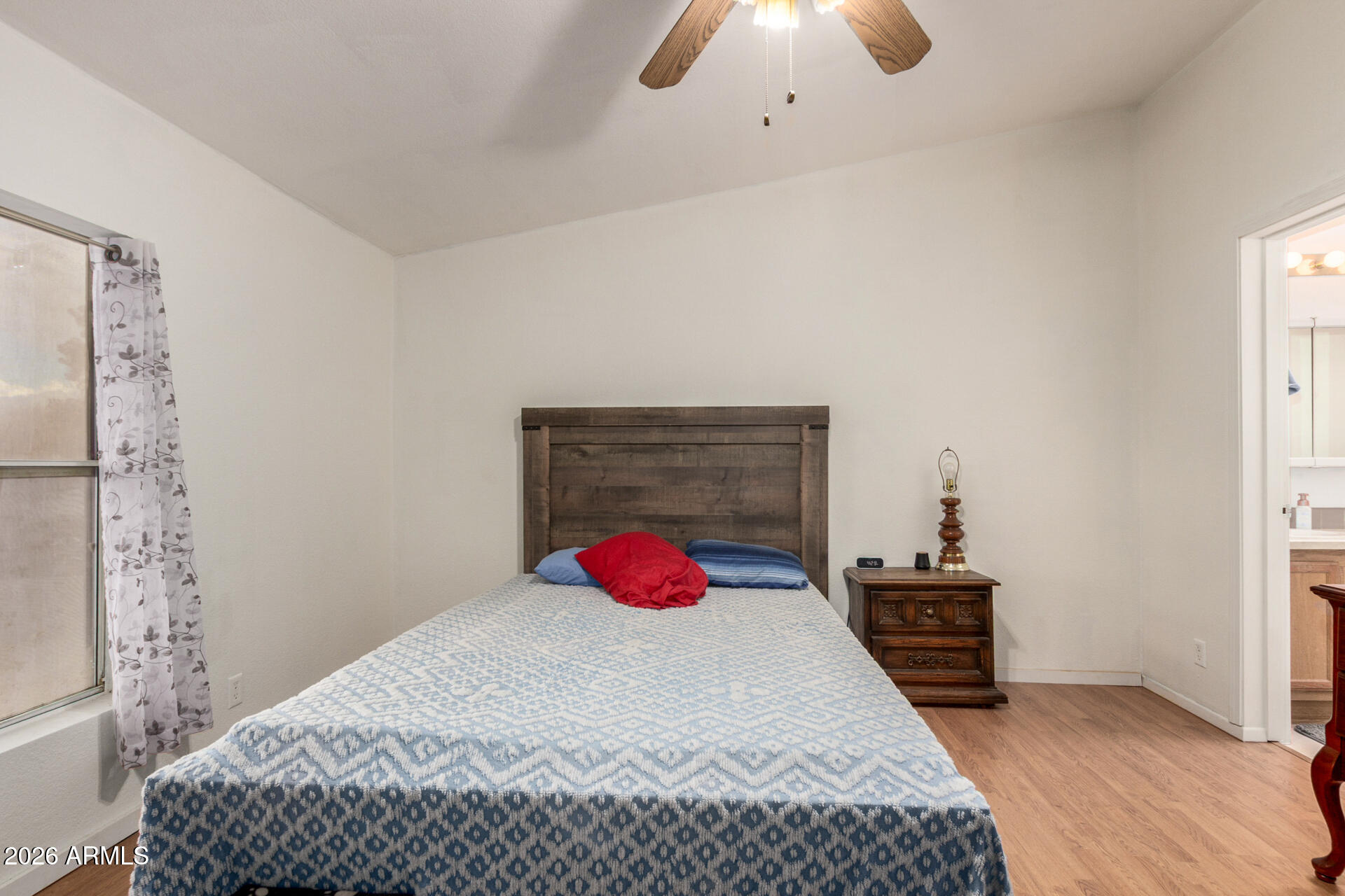 6751 West Nancy Road Peoria, AZ 85382 - Photo 15 of 29 a bedroom with a bed and a chandelier