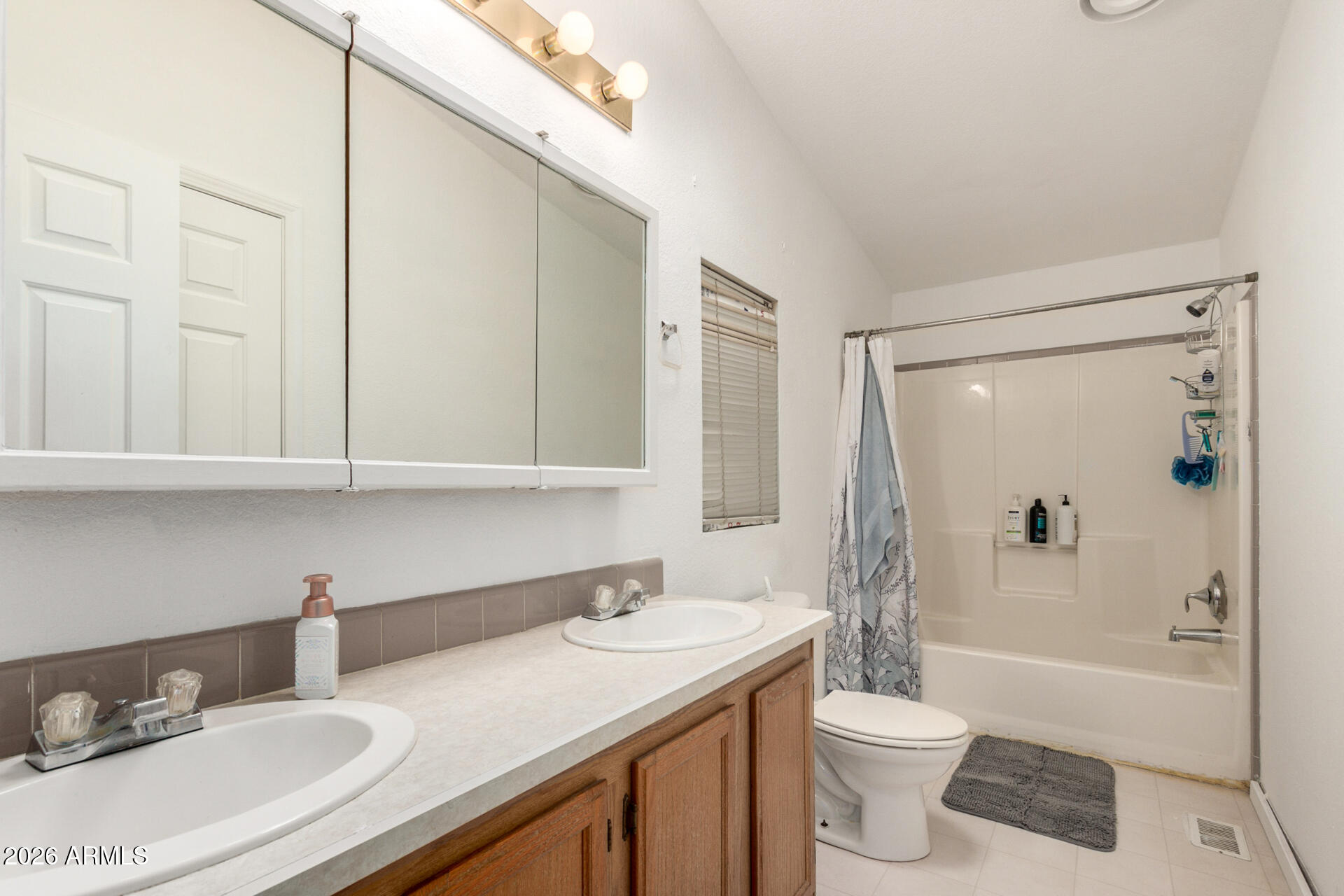 6751 West Nancy Road Peoria, AZ 85382 - Photo 17 of 29 a bathroom with a granite countertop sink toilet mirror and bathtub