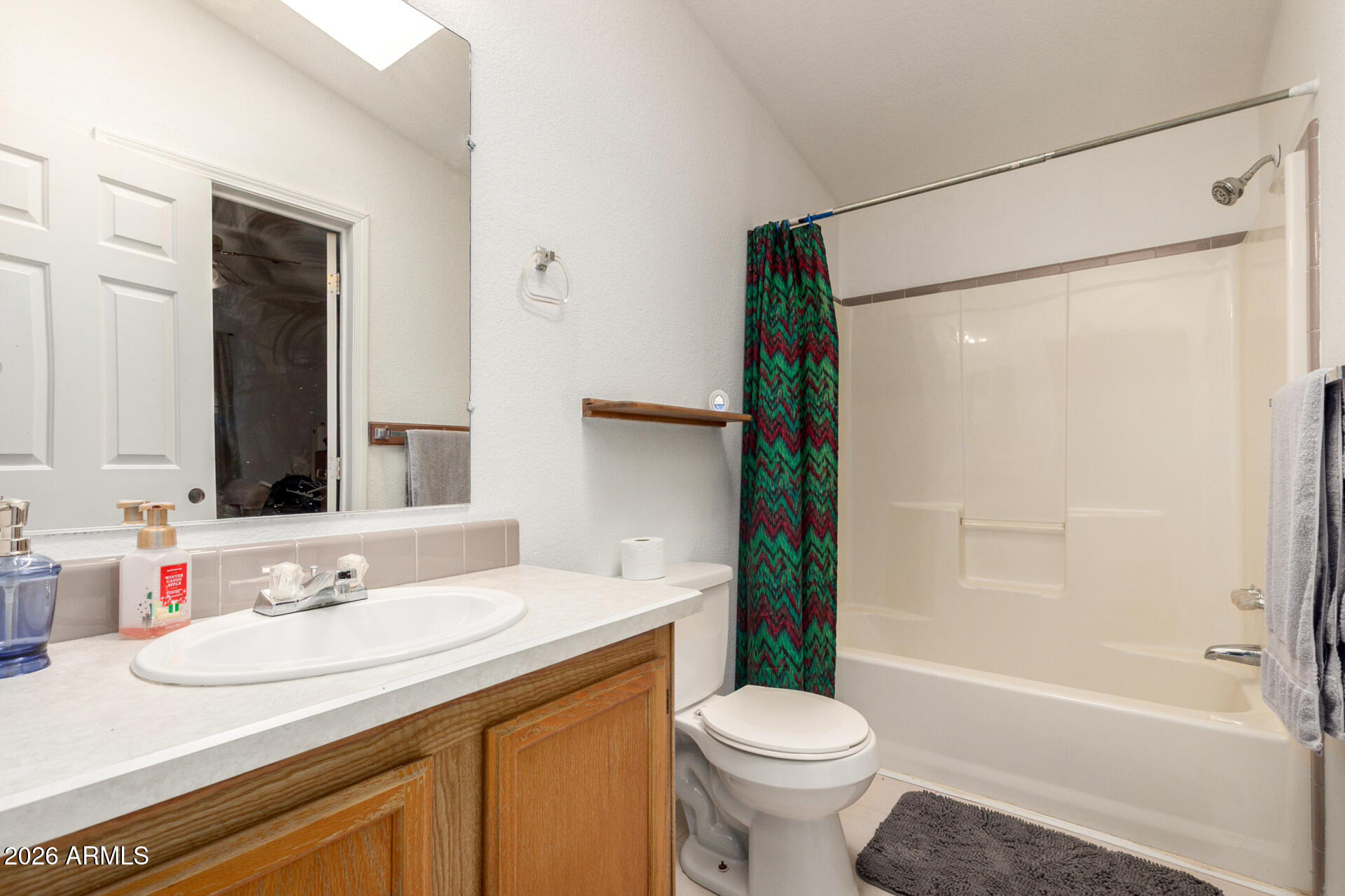 6751 West Nancy Road Peoria, AZ 85382 - Photo 20 of 29 a bathroom with a granite countertop sink toilet and shower