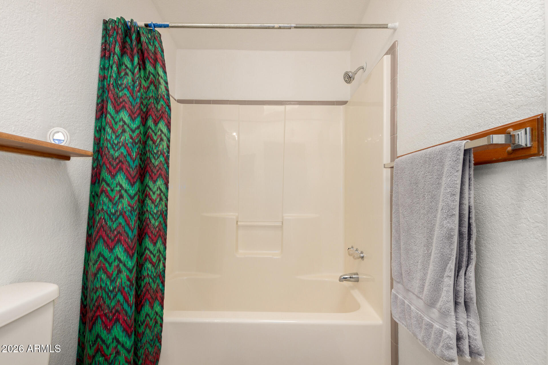 6751 West Nancy Road Peoria, AZ 85382 - Photo 21 of 29 a bathroom with a bathtub and a shower curtain