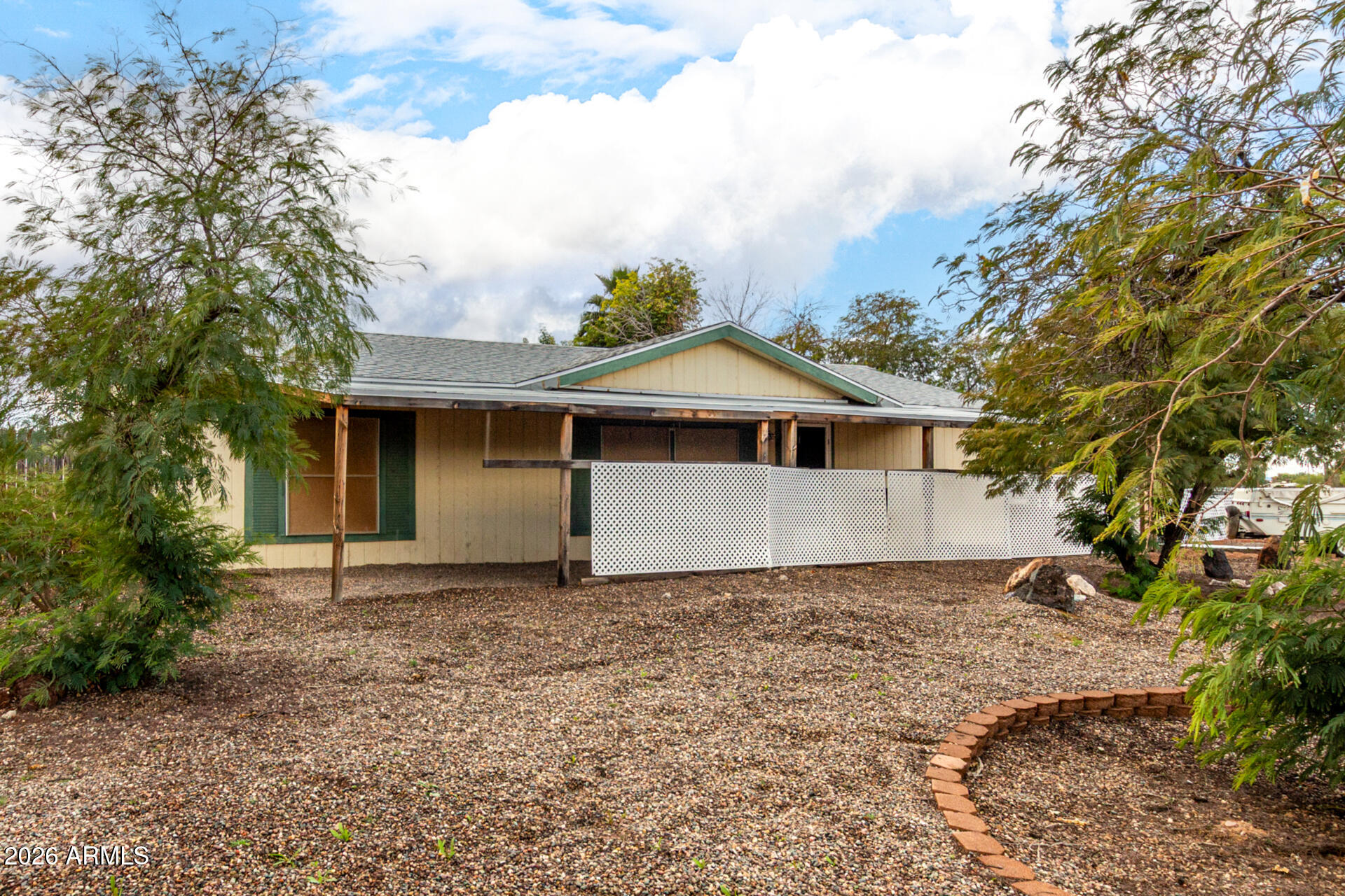 6751 West Nancy Road Peoria, AZ 85382 - Photo 4 of 29 a front view of a house with a garden