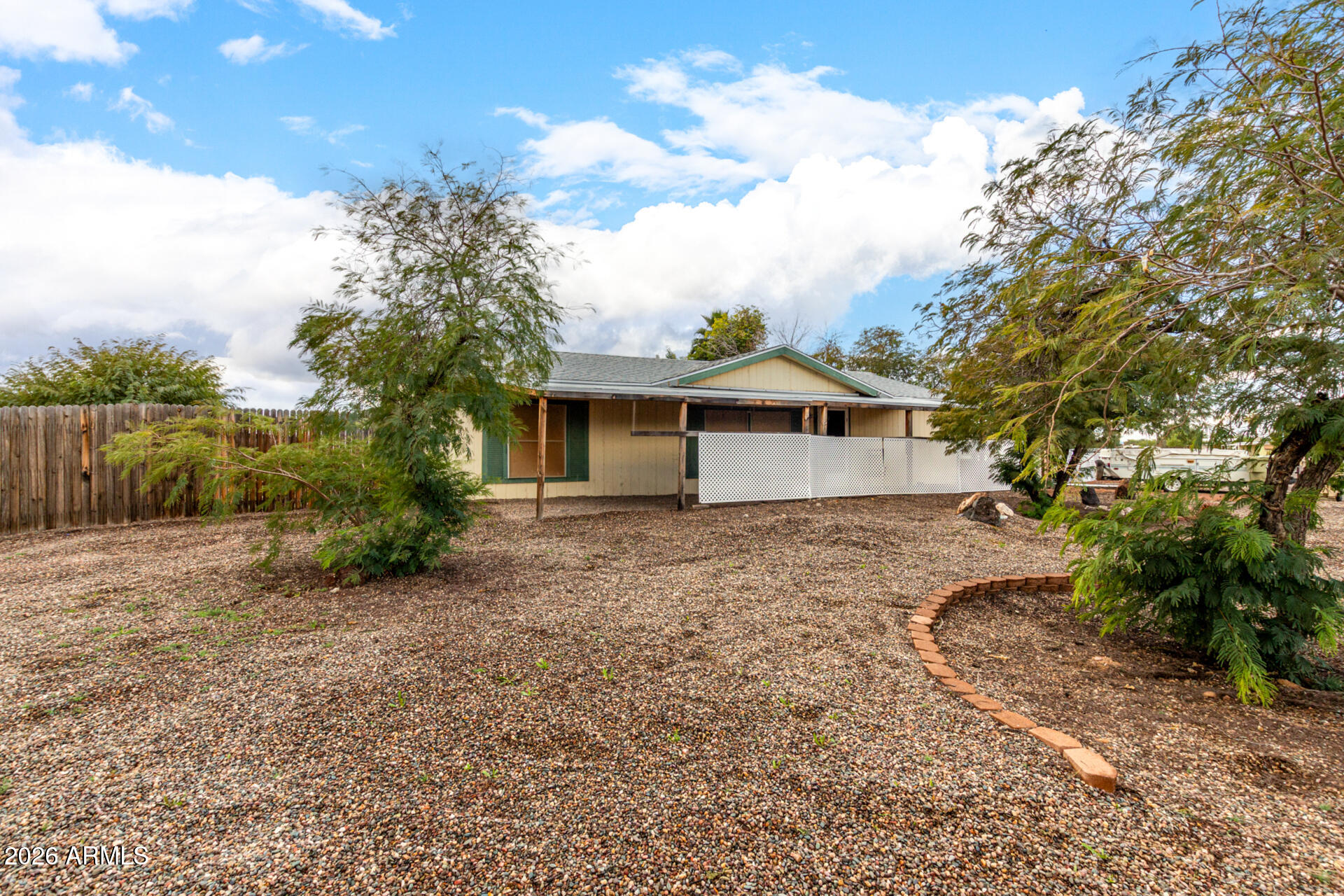 6751 West Nancy Road Peoria, AZ 85382 - Photo 5 of 29 a backyard of a house with plants and trees
