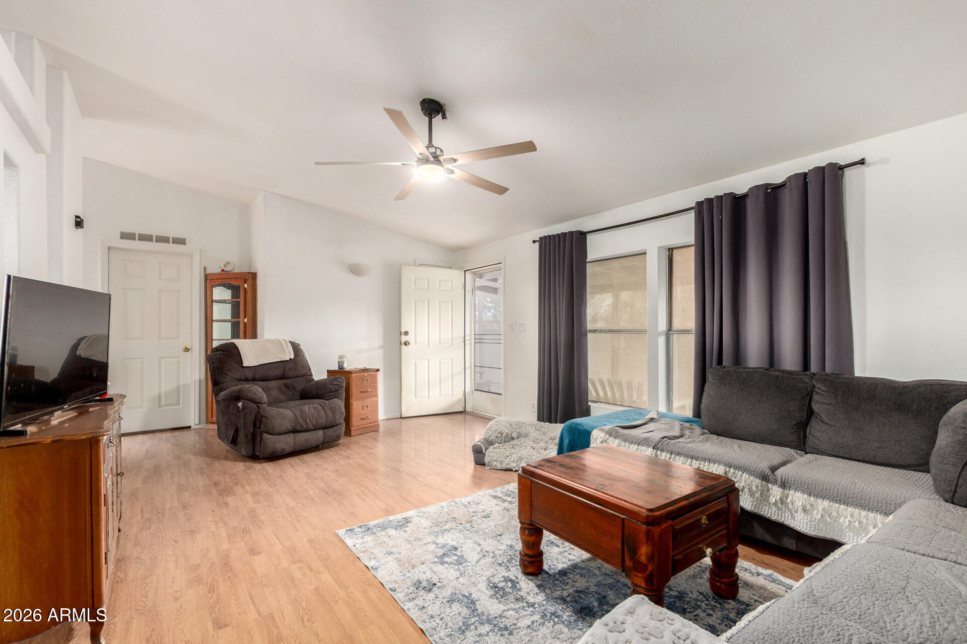 6751 West Nancy Road Peoria, AZ 85382 - Photo 9 of 29 a living room with furniture a flat screen tv and a window