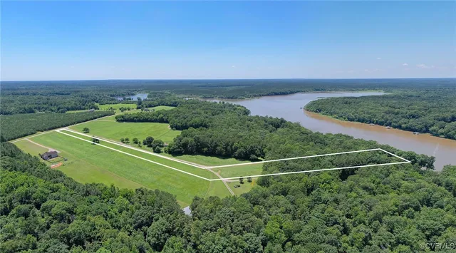 an aerial view of a houses with a yard