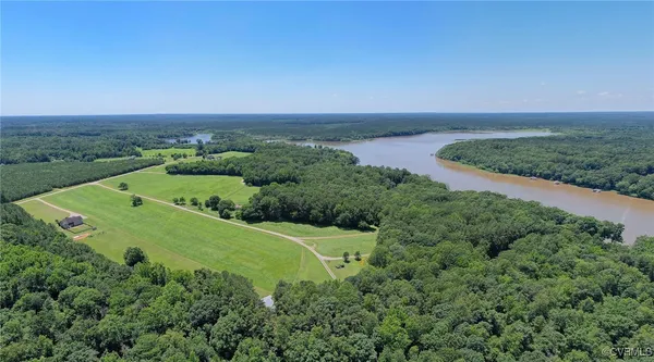 an aerial view of a houses with a yard