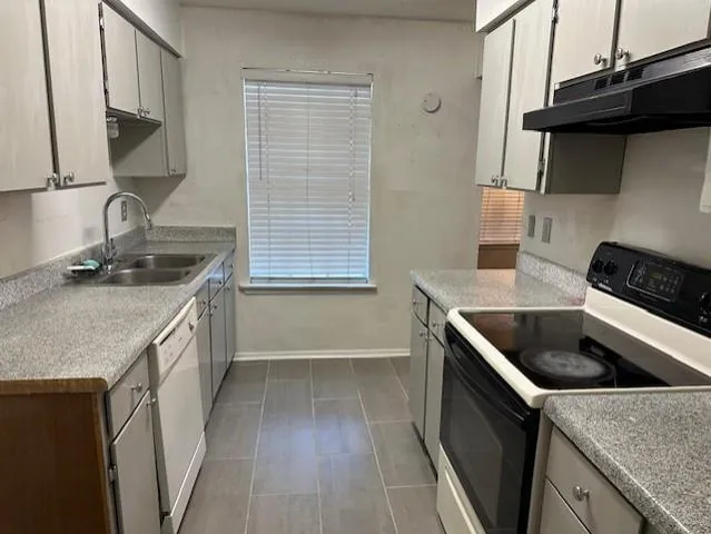 a kitchen that has a sink and a stove