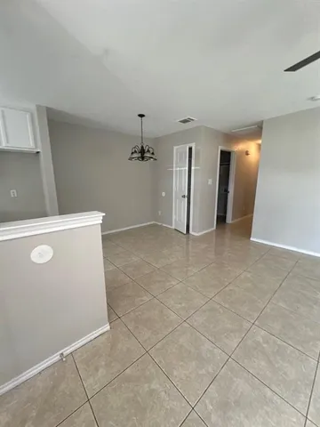 a kitchen with granite countertop a sink stove and cabinets