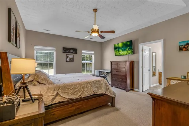 a bedroom with a bed dresser and a window