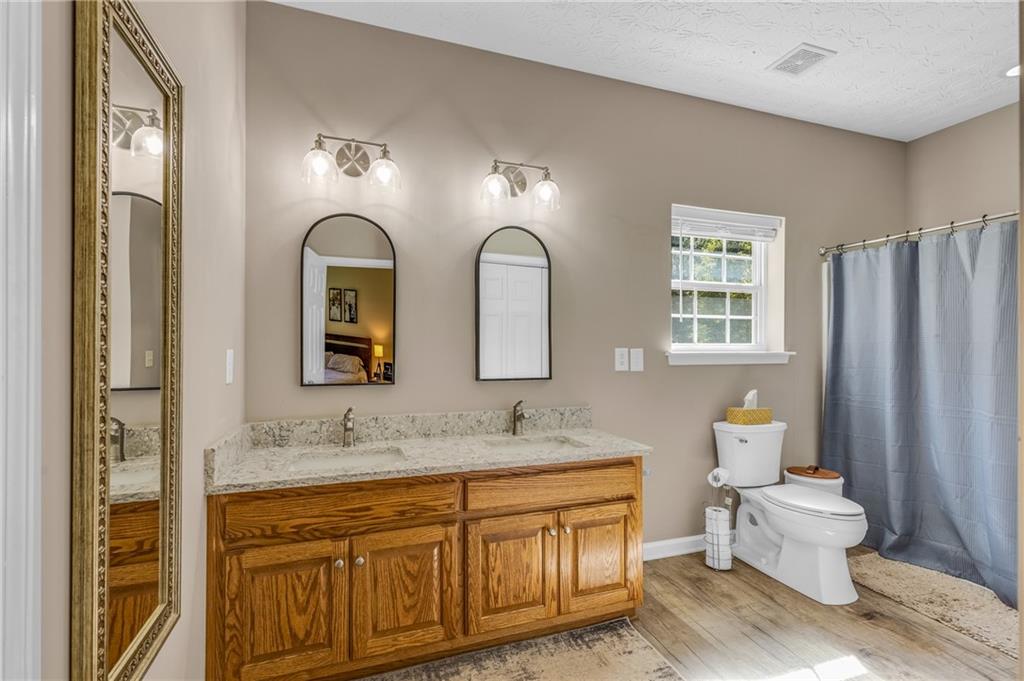 141 High Ridge Trail Jackson, GA 30233 - Photo 19 of 35 a spacious bathroom with a granite countertop sink and a mirror