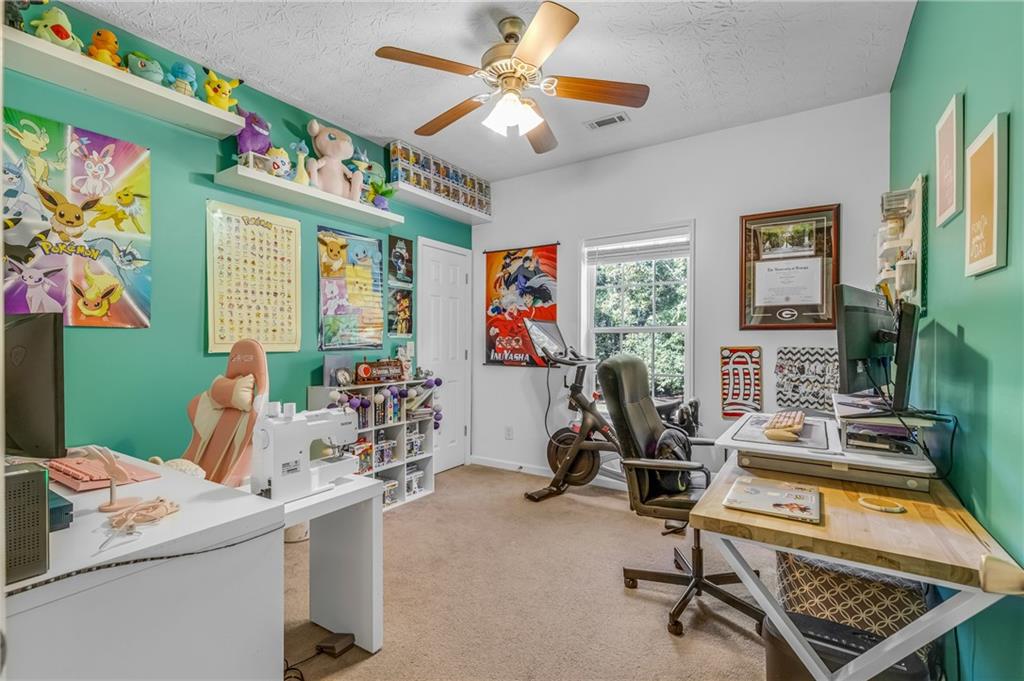 141 High Ridge Trail Jackson, GA 30233 - Photo 21 of 35 a room with furniture a chandelier and a flat screen tv