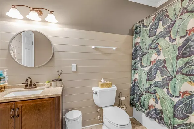 a bathroom with a toilet a sink and a mirror