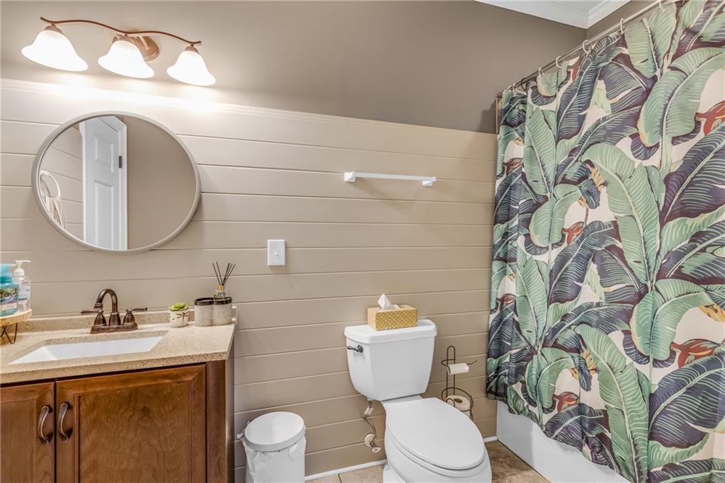 141 High Ridge Trail Jackson, GA 30233 - Photo 23 of 35 a bathroom with a toilet a sink and a mirror