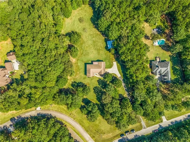 a view of green field with trees in the background
