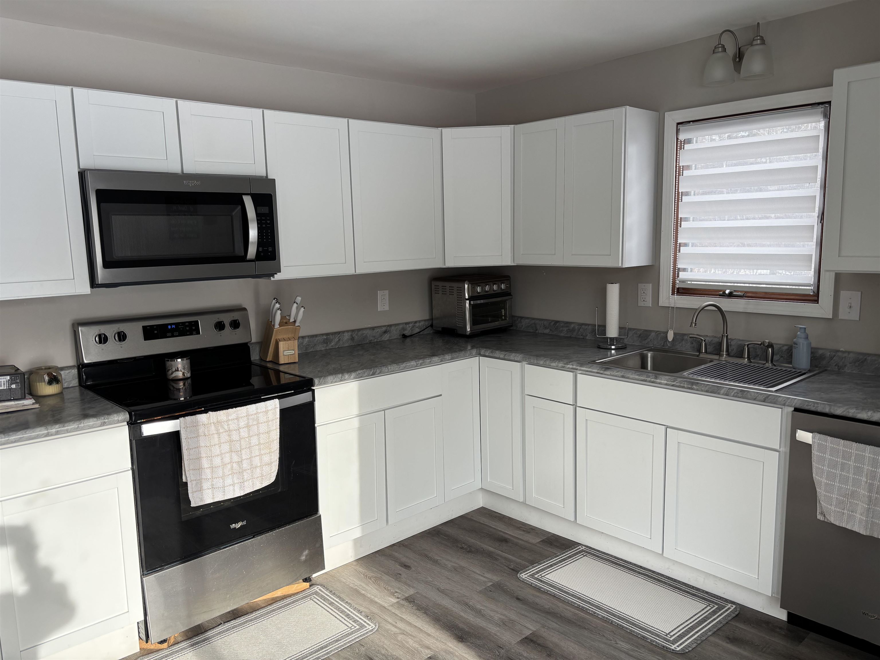9688 Highway 37 Iron, MN 55751 - Photo 5 of 14 Kitchen featuring stainless steel appliances, white cabinets, and dark wood-type flooring