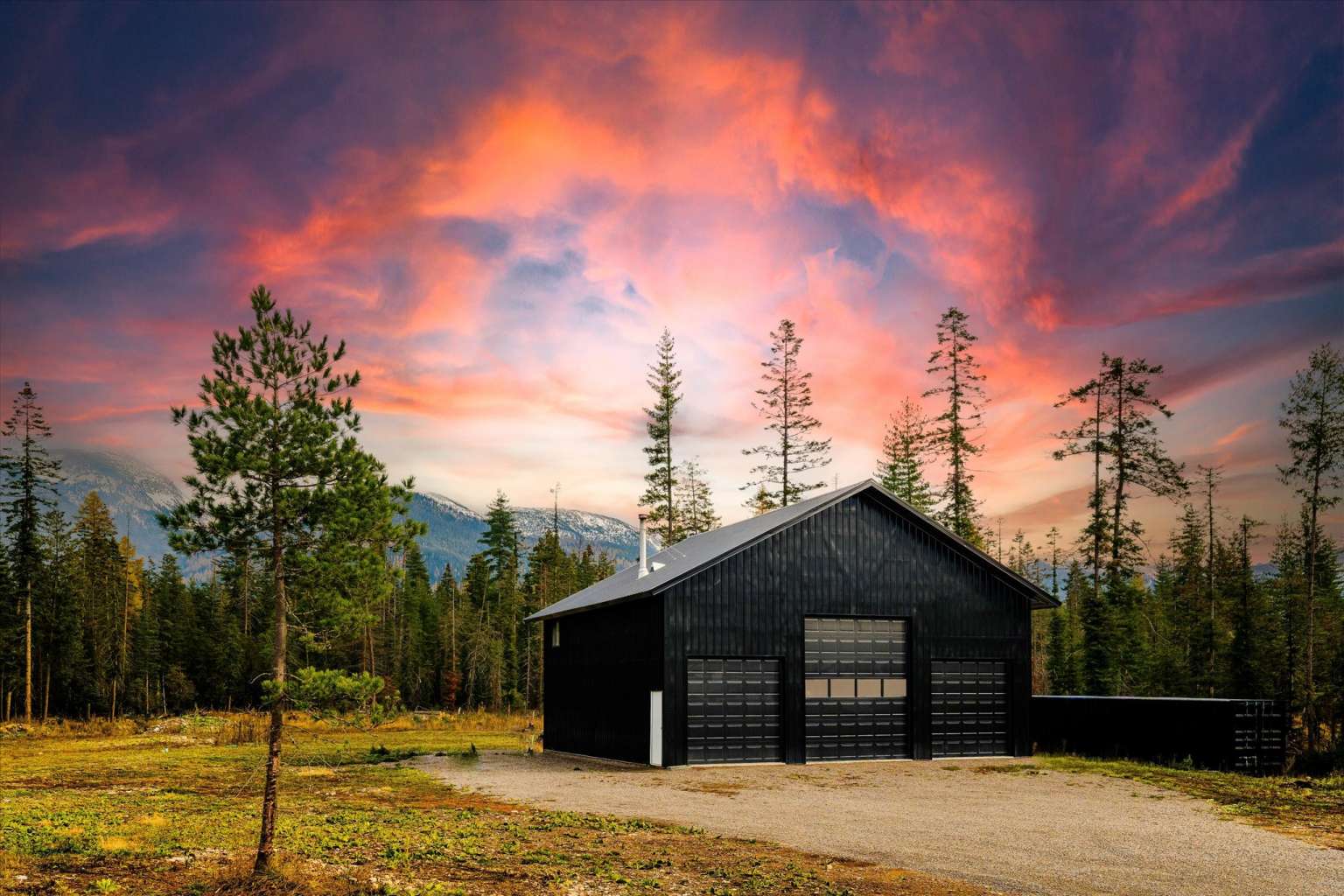 1210 Grand Fir Road Bigfork, MT 59911 - Photo 1 of 1 Outdoor structure at dusk featuring a view of trees
