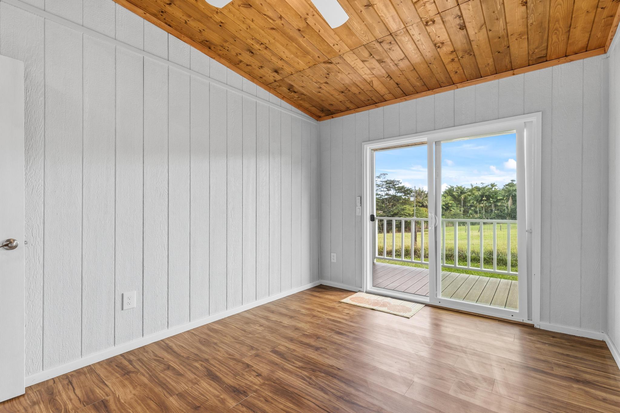 7 Iliopua Road Honomu, HI 96728 - Photo 13 of 30 a view of a big room with wooden floor and doors