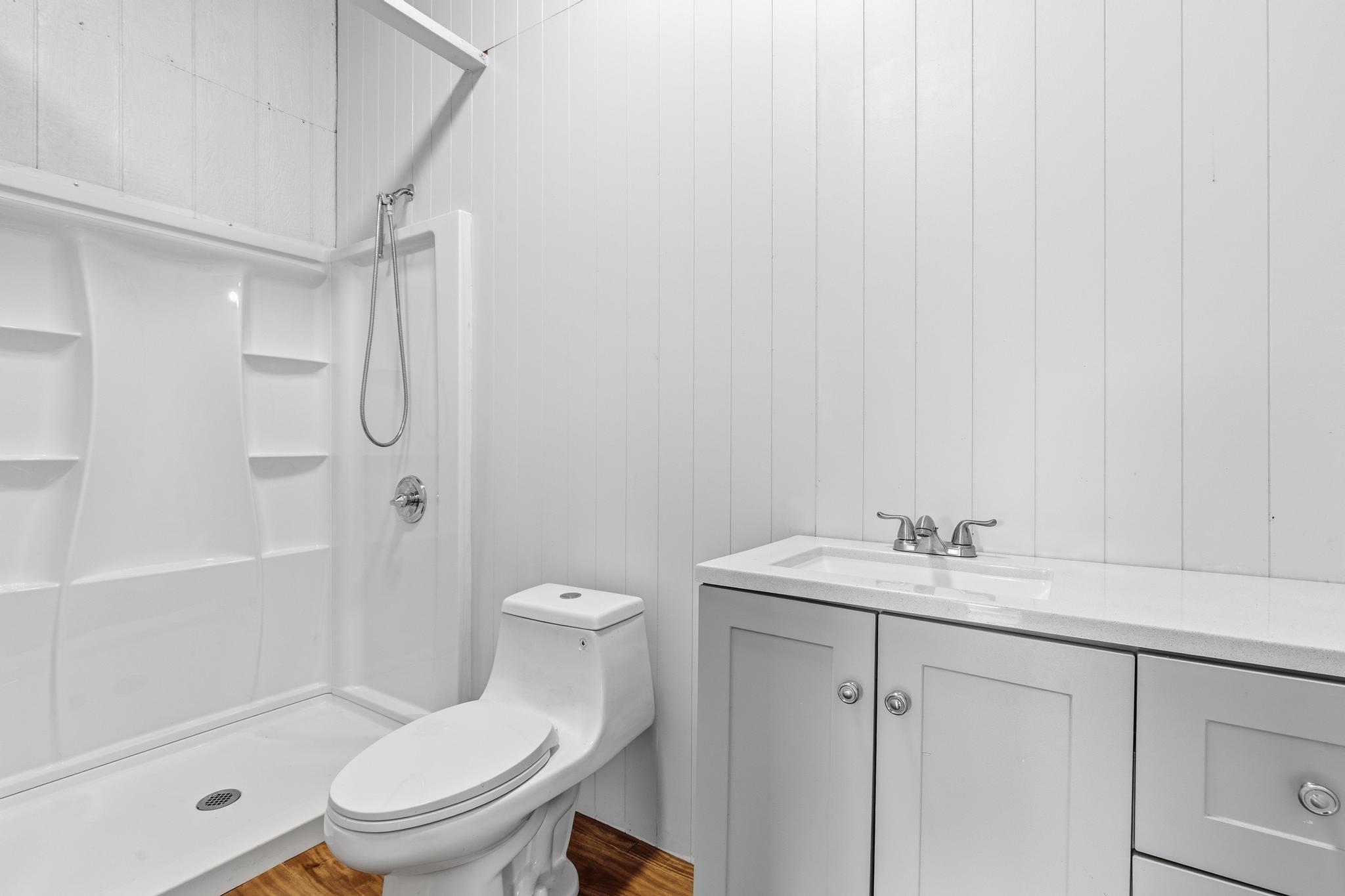 7 Iliopua Road Honomu, HI 96728 - Photo 14 of 30 a bathroom with a sink a toilet and shower