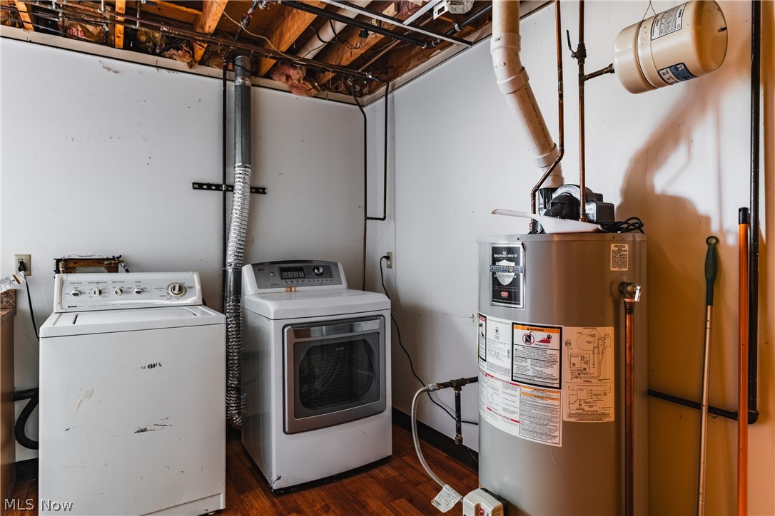 279 Spence Road Belpre, OH 45714 - Photo 31 of 40 Clothes washing area featuring dark wood-type flooring, gas water heater, and washing machine and clothes dryer