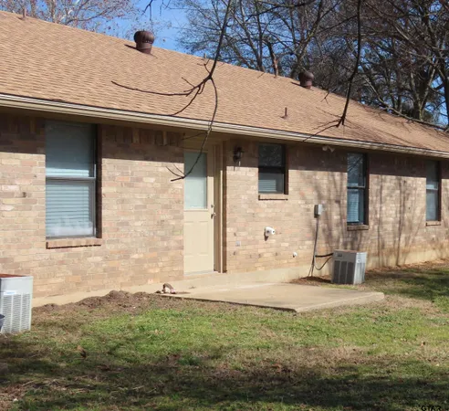 a side view of a house with a yard