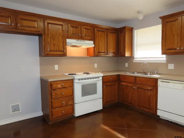 a kitchen with stainless steel appliances granite countertop a stove and a sink