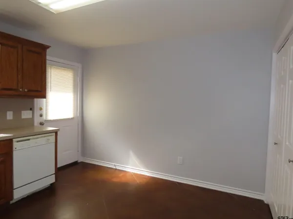 a room with a stove top oven a sink and dishwasher with wooden floor
