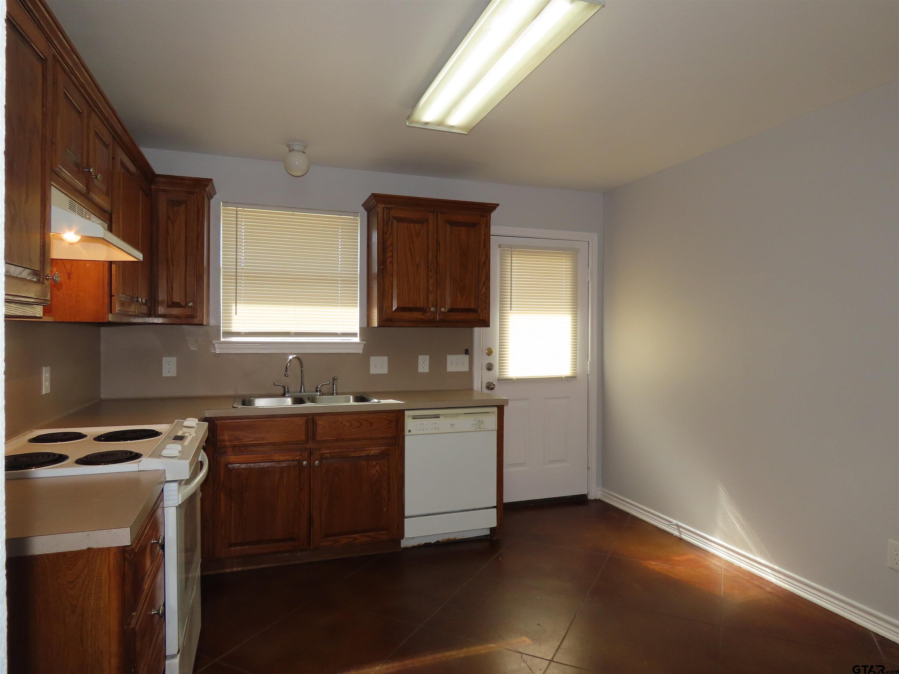 203 Memory Lane, Unit D Whitehouse, TX 75791 - Photo 7 of 16 a kitchen with a sink a window and cabinets