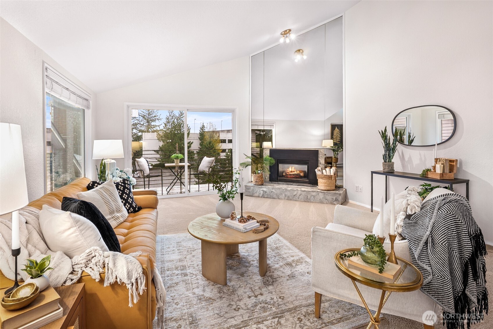 a living room with furniture a fireplace and a table