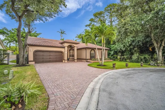 a view of a house with a backyard and a small yard