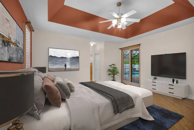 a bedroom with a bed window and a flat screen tv