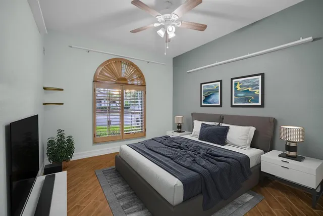 a bedroom with a bed and a painting on the wall