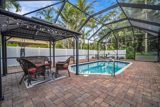 an aerial view of residential houses with outdoor space and trees