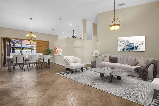 a living room with furniture and a chandelier