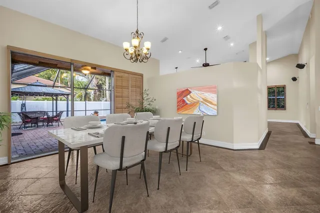 a view of a dining room with furniture large windows and wooden floor